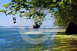 Secluded blue lagoon with  boulder in the sea near Portland, Jamaica