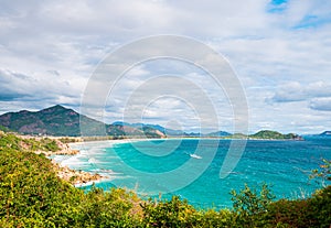 Secluded tropical coast line turquoise transparent water palm trees, undeveloped bay Quy Nhon Nha Trang, Vietnam central coast