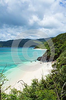 Secluded tropical paradise beach with clear blue lagoon water, Amami Oshima Island, Japan