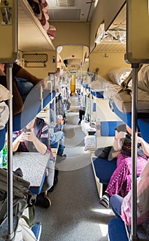 Second-class carriage with passengers in the Russian train. Long distance trains