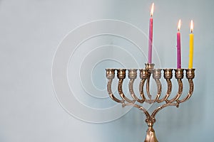 Second day of Hanukkah with burning Hanukkah colorful candles in Menorah. Copy space for text. photo