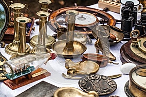 Second hand brass candle holders at antique dealer show