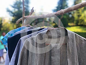 Second hand garage sale outdoors. Rack of old fashioned women& x27;s clothes for reselling,recycling,donation,reusing or