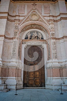 Secondary door of the Basilica of San Petronio in Piazza Maggiore in Bologna, Italy