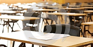 Secondary High School college hall set up with student exam examination papers ready to sit