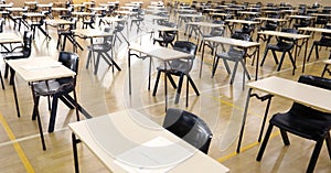 Secondary High School college hall set up with student exam examination papers ready to sit