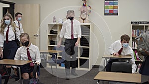 Secondary school students in UK wear masks as they enter class and sit down