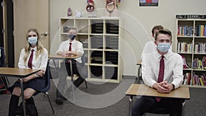 Secondary school students in UK wear masks in class with desks spaced apart