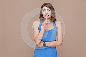 Secrecy woman looking at camera and showing shh or hush sign
