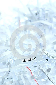 Secrecy written on shredded paper