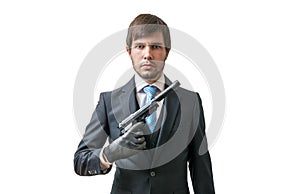 Secret agent or murderer with pistol in hand. Isolated on white.