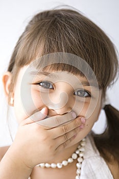 Secret. Beautiful curious girl with a bead