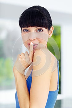 Secret, gossip and portrait of woman at her home with finger on her mouth in her modern home. Whisper, silence hand