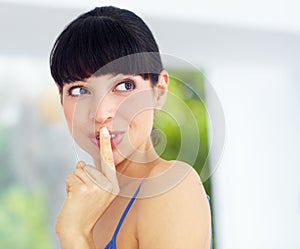 Secret, gossip and young woman at her home with finger on her mouth in her modern home. Whisper, silence hand gesture