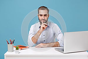 Secret man in shirt sit work at desk with pc laptop isolated on blue background. Achievement business career lifestyle