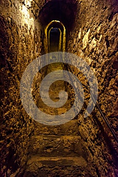 Secret narrow stone stairs tunnel