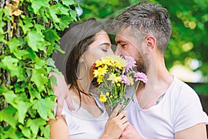 Secret romantic kiss. Love romantic feelings. Moment of intimacy. Couple in love hiding behind bouquet flowers kiss