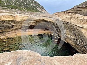 Secret sandy cave beach Saint-Antoine with turquoise water at Capo Pertusatu close to Bonifacio. Corsica, France.