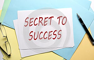 SECRET TO SUCCESS text on paper on the colorful paper background