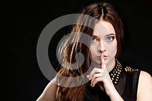 Secret woman. Girl showing hand silence sign