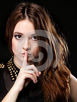 Secret woman. Girl showing hand silence sign