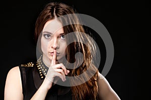 Secret woman. Girl showing hand silence sign