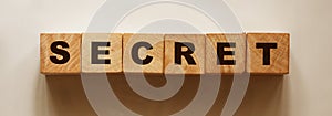 Secret word on wood cubes. Business, education or scandal reveal concept