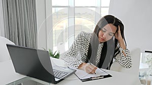 Secretary crumples documents, beautiful girl manager prints text on laptop at desk in white office, financial crisis