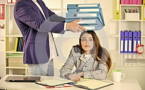 secretary with many folders. modern office life. woman and man do business. businessman consulting with colleague. make