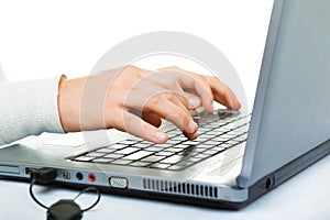Secretary's hand touching computer keys