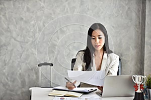 The secretary or staff or accounting officer. At her desk photo