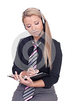 Secretary wearing a headset writing notes