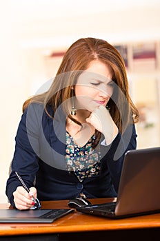 Secretary working with laptop and tablet