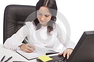 Secretary working in office using laptop