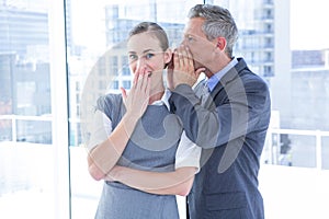 Secretive business colleagues whispering