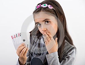 Secretive young girl showing her poker hand