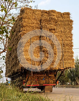 A section of an agricultural vehicle loaded with bales of straw