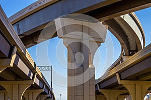 Section of elevated highway with several levels against a bright blue sky in Houston, Texas