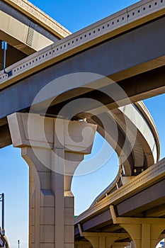 Section of elevated highway with several levels against a bright blue sky in Houston, Texas