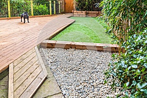 A section of a residntial garden, yard with wooden decking,