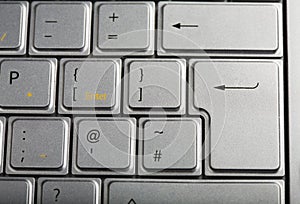 Section of a silver laptop keyboard