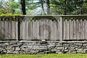 Section of Stacked Stone Wall with Distressed Wood Fence.