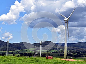 A section of a wind farm shows three wind turbines in the Atherton Tablelands