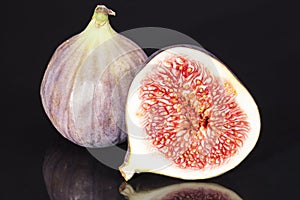 Sectioned fruit figs isolated on black background