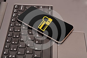 Secure Credit Card icon in smartphone laid on keyboard