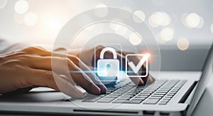 Secure data entry hands typing on laptop with digital lock and checkmark symbol technology