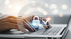 Secure data entry hands typing on laptop with digital lock and checkmark symbol technology