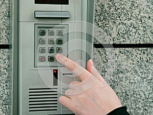 Hands Pressing on Intercom