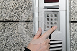 Hands Pressing on Intercom