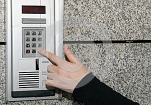 Hands Pressing on Intercom